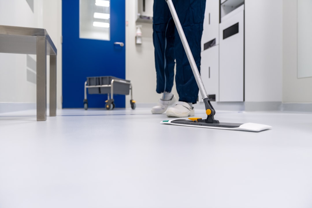 A cleaner is mopping the floor in a laboratory setting